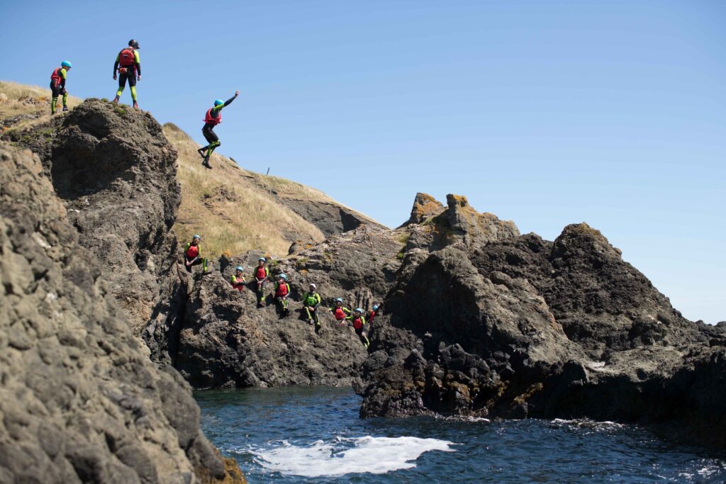 Jumping from a cliff in Shell Bay | Private coasteering adventure